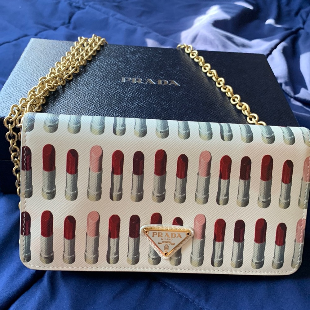 Prada Mini small crossbody bag in lipstick-printed saffiano calf leather.